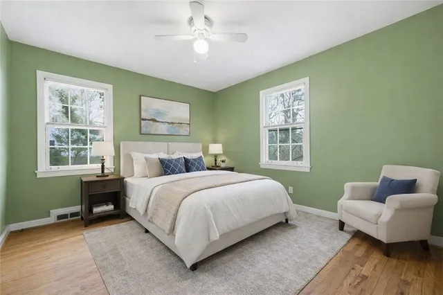 a bedroom with a bed couch and a window