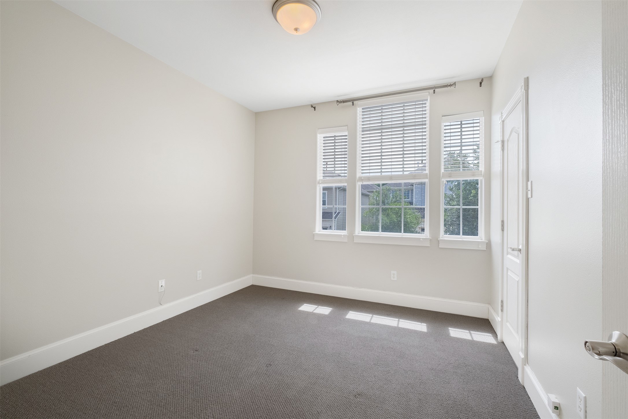 6715 Windrift Way, Unit 8 Austin, TX 78745 - Photo 19 of 24 Natural light streams into this generously proportioned room, offering a serene and versatile living space.