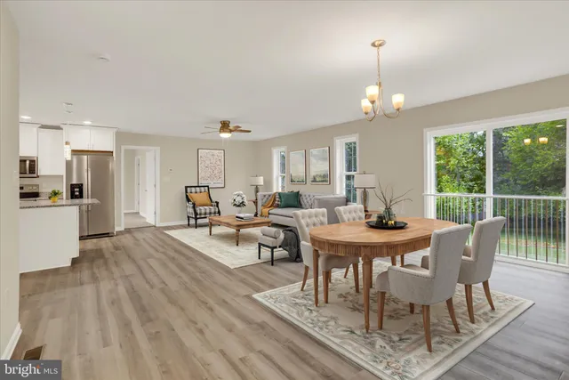 a view of a dining room with furniture window and wooden floor