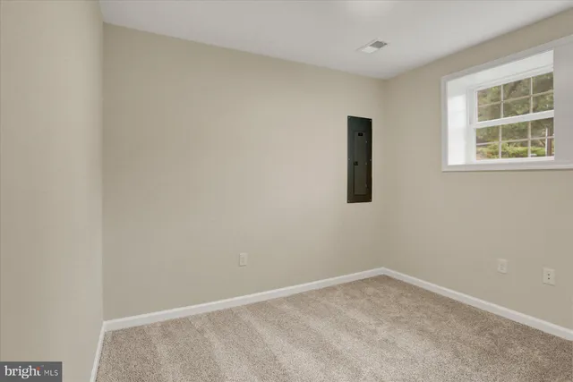 an empty room with windows and closet