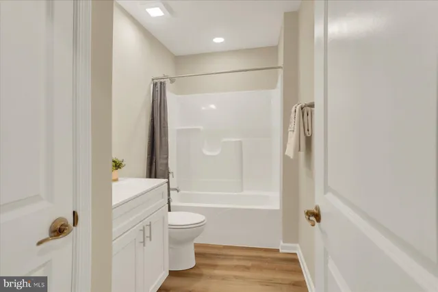 a bathroom with a shower a toilet and a shower