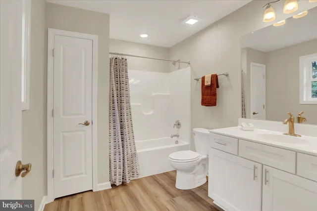 a bathroom with a sink toilet a shower and a mirror