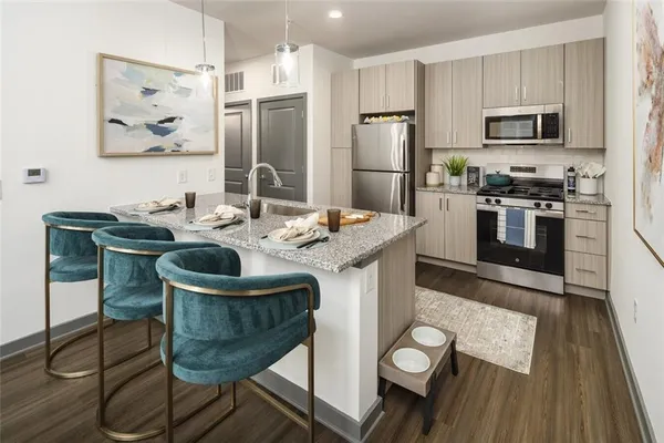 a kitchen with a table chairs refrigerator and stove