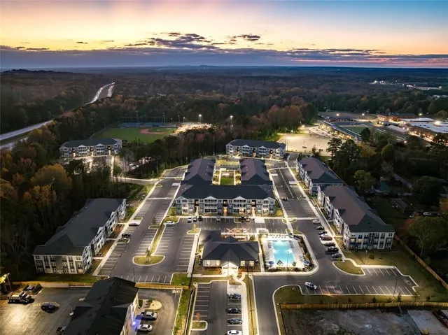 a kitchen with stainless steel appliances granite countertop a stove a refrigerator a microwave a sink and white cabinets