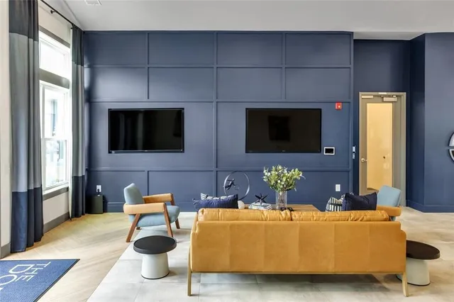 a view of a patio with couches table and chairs under an umbrella
