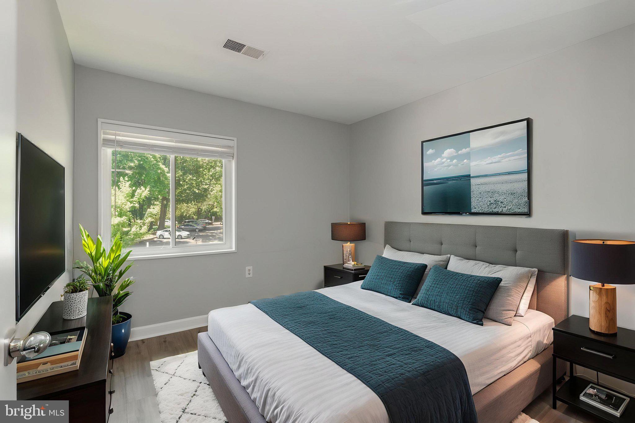 1443 Northgate Square, Unit 22B Reston, VA 20190 - Photo 16 of 42 a bedroom with bed plant and a window