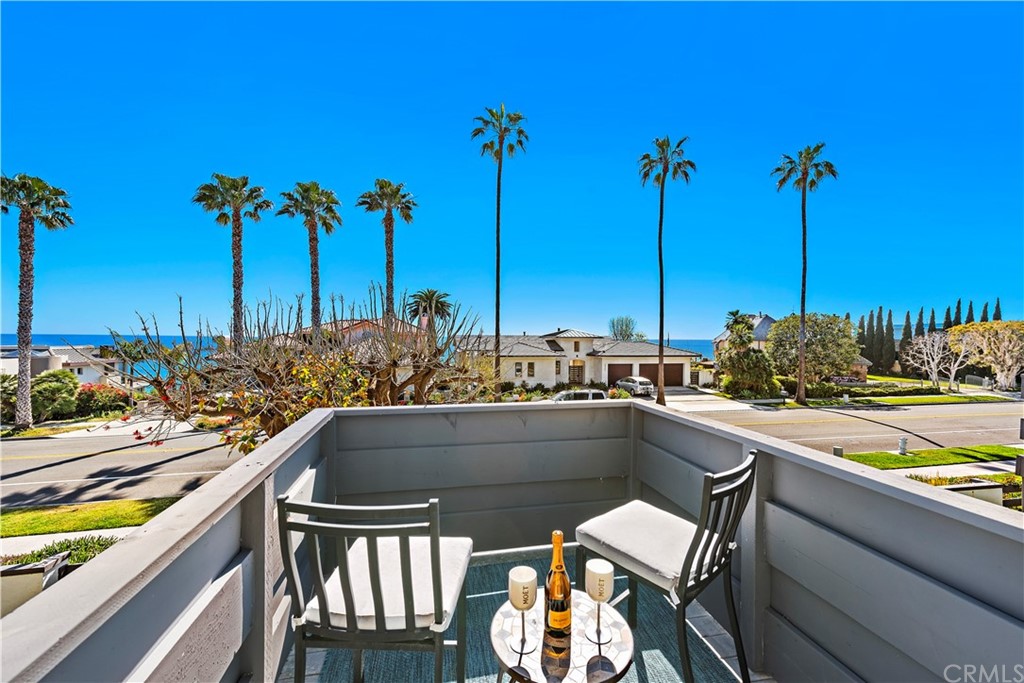 a view of a chairs and table on the balcony