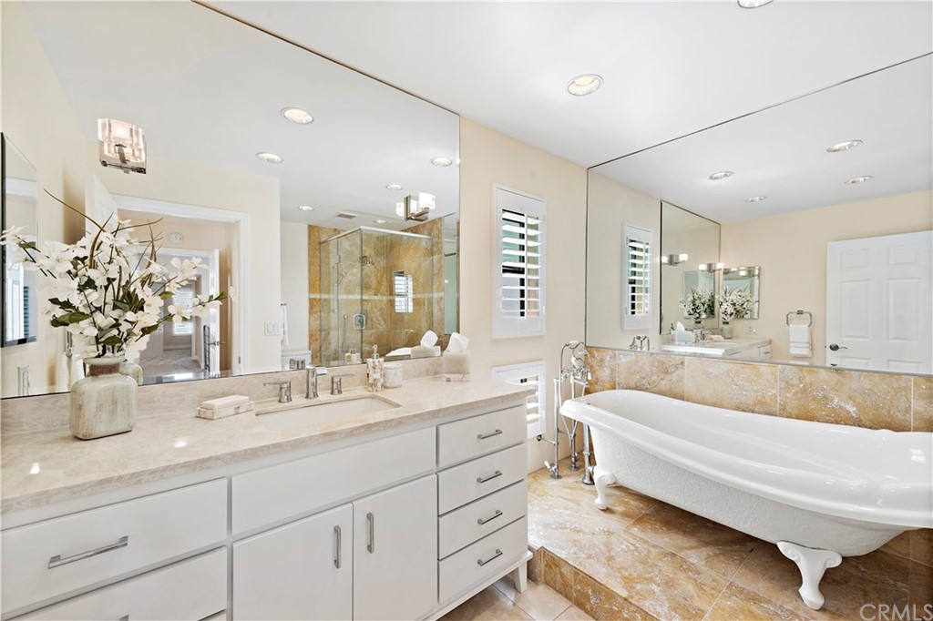 35232 Camino Capistrano, Unit 6 Dana Point, CA 92624 - Photo 15 of 25 a spacious bathroom with double vanity a mirror and a bathtub