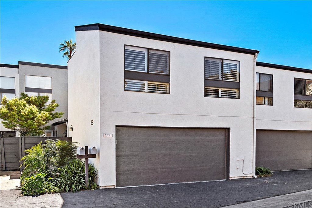35232 Camino Capistrano, Unit 6 Dana Point, CA 92624 - Photo 19 of 25 a front view of a house with a yard and garage
