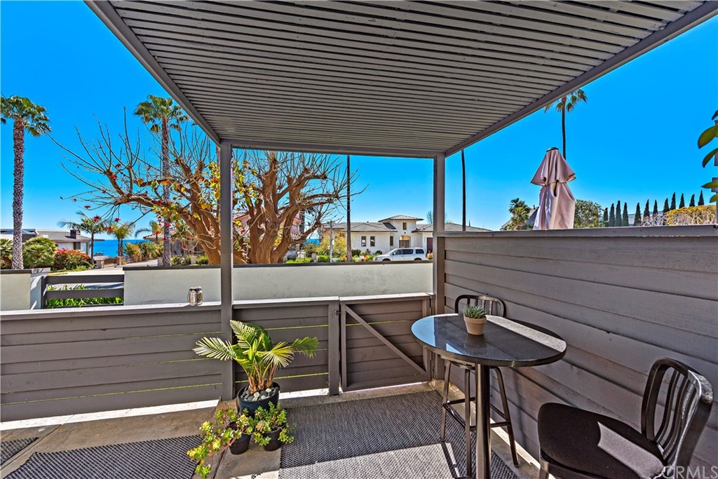 35232 Camino Capistrano, Unit 6 Dana Point, CA 92624 - Photo 7 of 25 a roof deck with table and chairs and potted plants