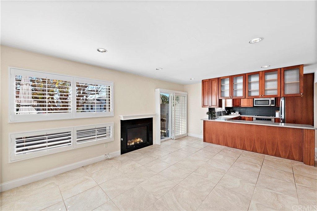 35232 Camino Capistrano, Unit 6 Dana Point, CA 92624 - Photo 8 of 25 a large white kitchen with granite countertop a stove top oven a sink and dishwasher
