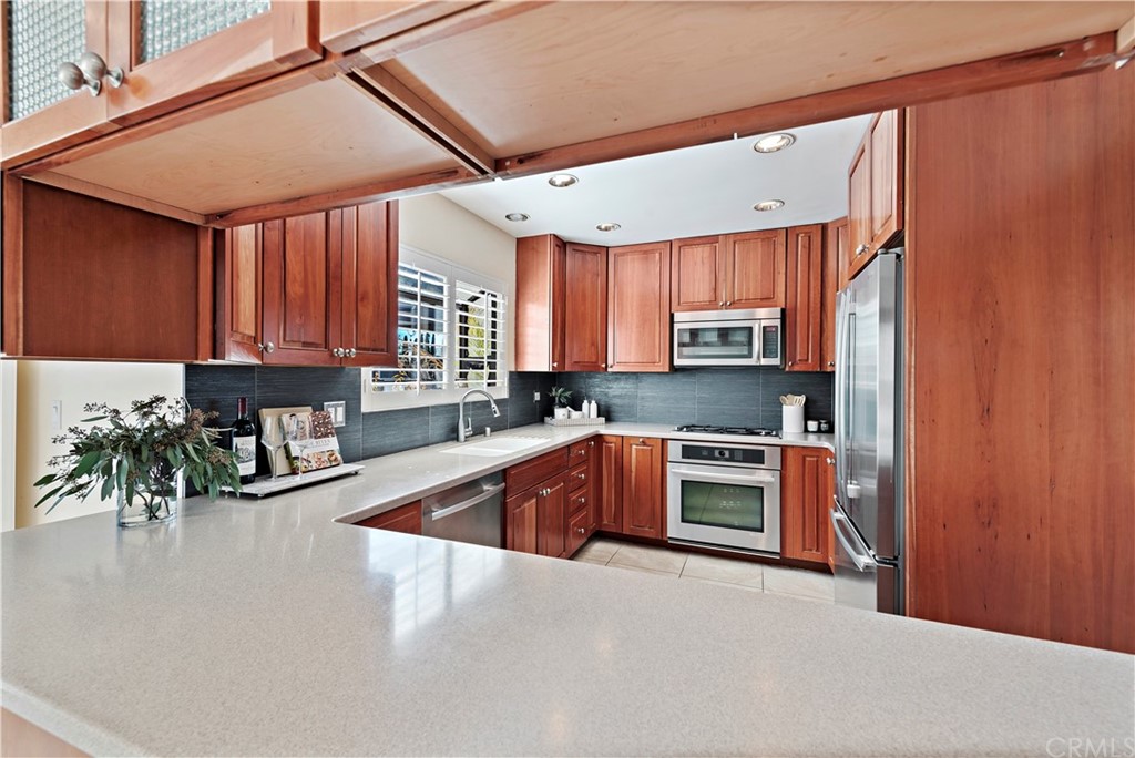 35232 Camino Capistrano, Unit 6 Dana Point, CA 92624 - Photo 9 of 25 a kitchen with stainless steel appliances granite countertop a stove a sink and a microwave