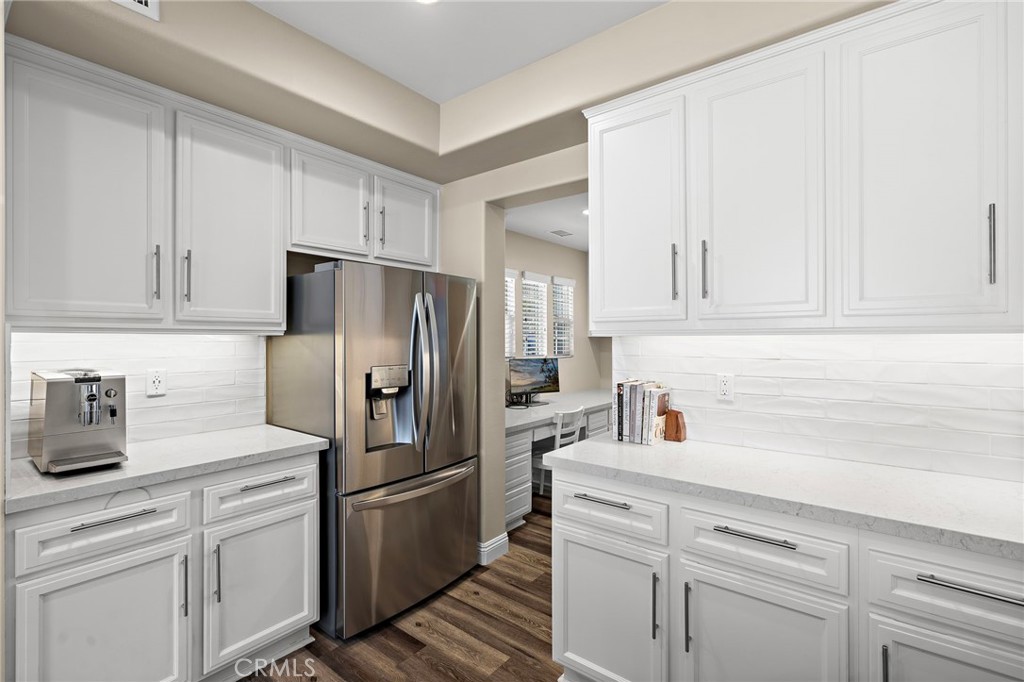 71 Sklar Street Ladera Ranch, CA 92694 - Photo 13 of 55 a kitchen with white cabinets and stainless steel appliances