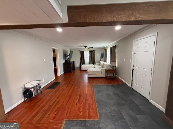 a living room with furniture and a flat screen tv