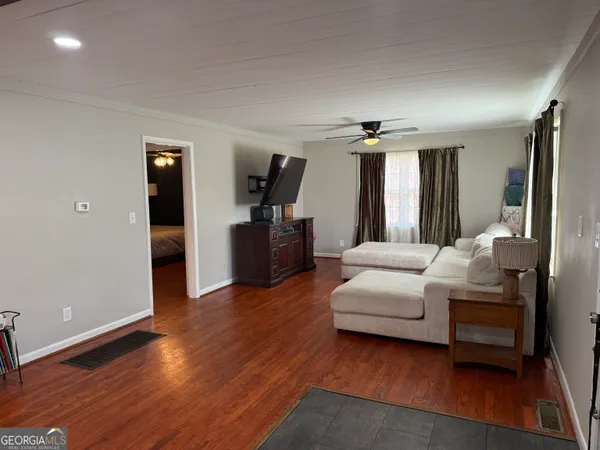 a living room with furniture and wooden floor