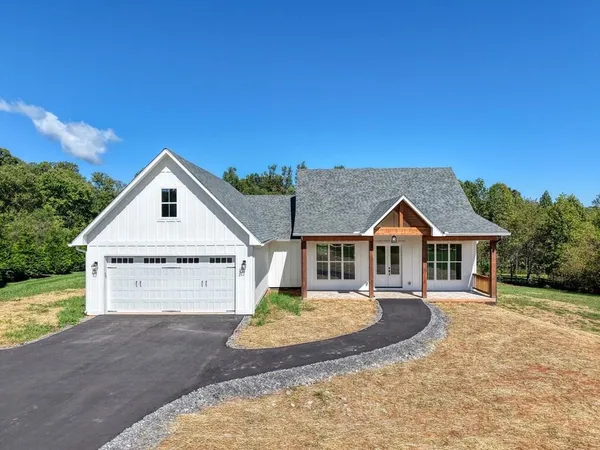 a view of a house with a yard balcony and roof