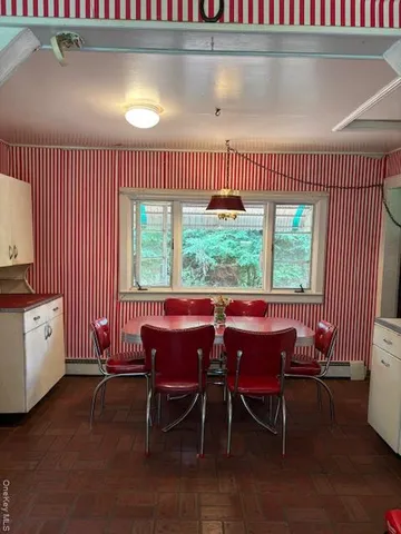 a kitchen with a sink cabinets and wooden floor