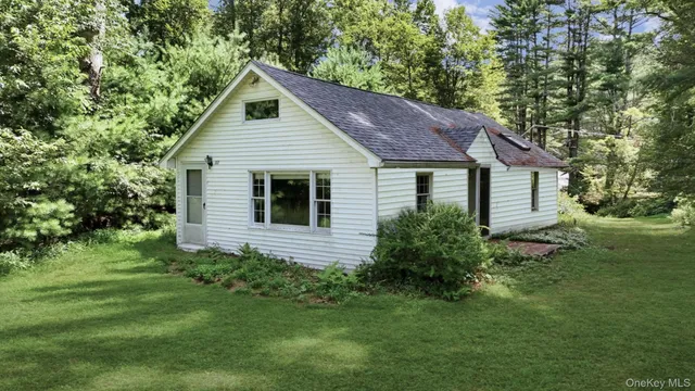 a front view of house with a garden