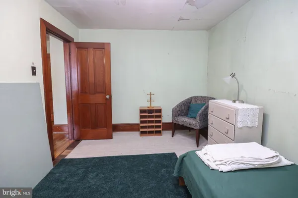 a bedroom with furniture and a mirror