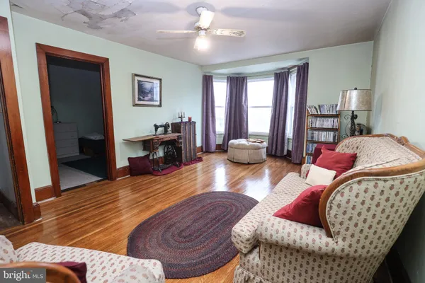 a bedroom with furniture and a wooden floor