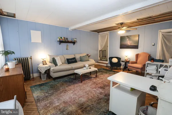 a living room with furniture and a lamp