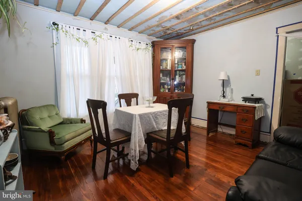 a dining room with furniture and wooden floor