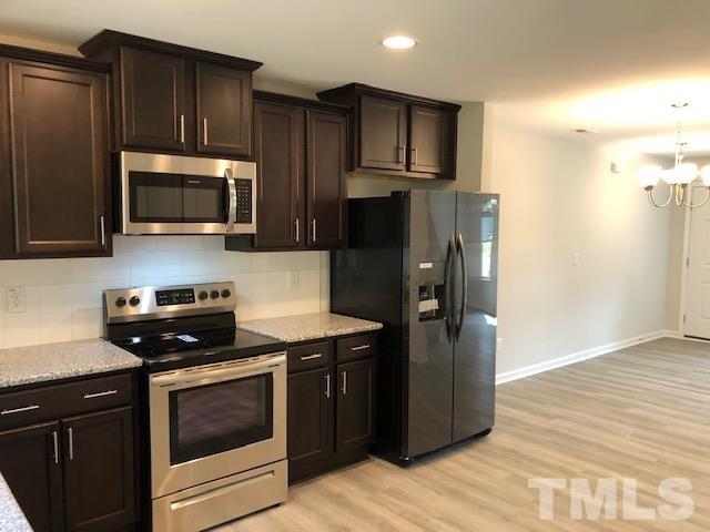 252 Spark Street Raleigh, NC 27606 - Photo 1 of 12 a kitchen with a refrigerator stove and microwave