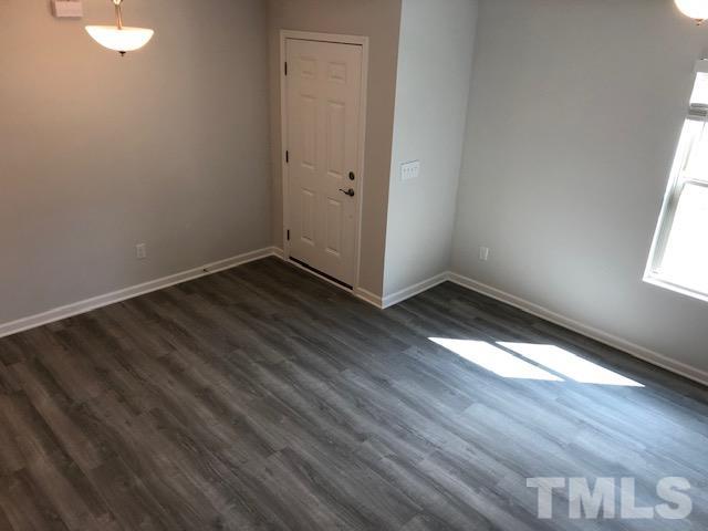 252 Spark Street Raleigh, NC 27606 - Photo 8 of 12 a view of an empty room with wooden floor and a window