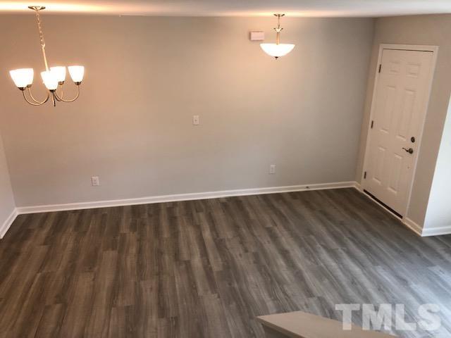 252 Spark Street Raleigh, NC 27606 - Photo 9 of 12 a view of a room with wooden floor and a ceiling fan