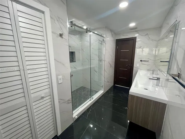 a bathroom with a double vanity sink and mirror