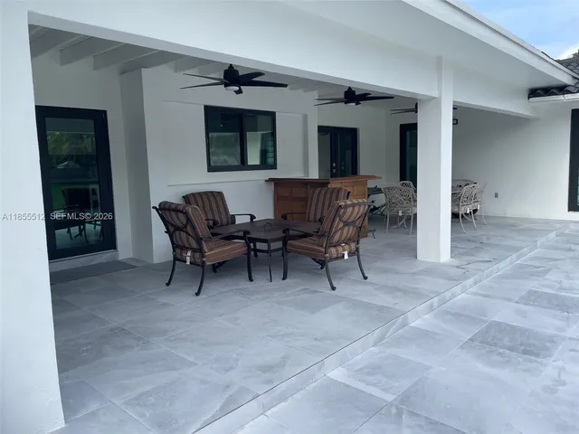 a view of a backyard with sitting area