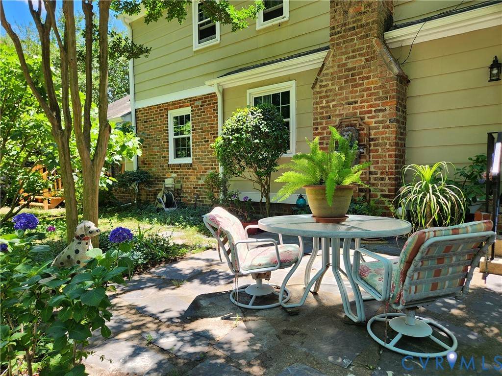 10260 Maplested Lane Henrico, VA 23229 - Photo 30 of 38 Stone patio with brick chimney, featuring green si