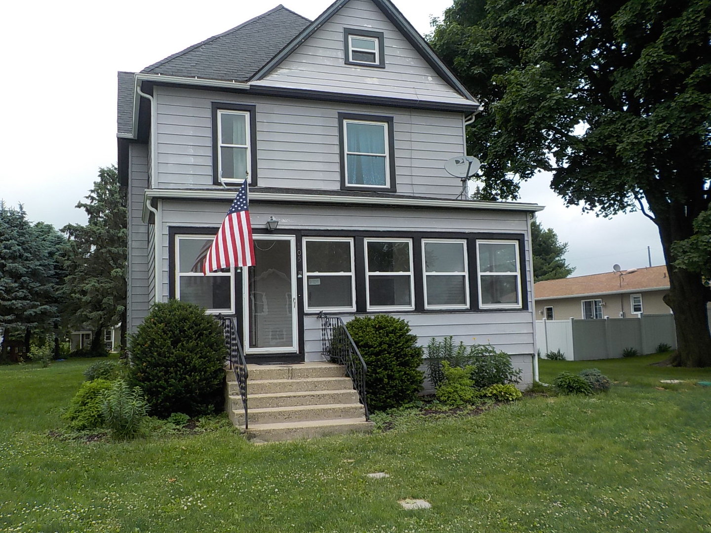 105 Main Street Kings, IL 61068 - Photo 1 of 19 a front view of a house with a yard
