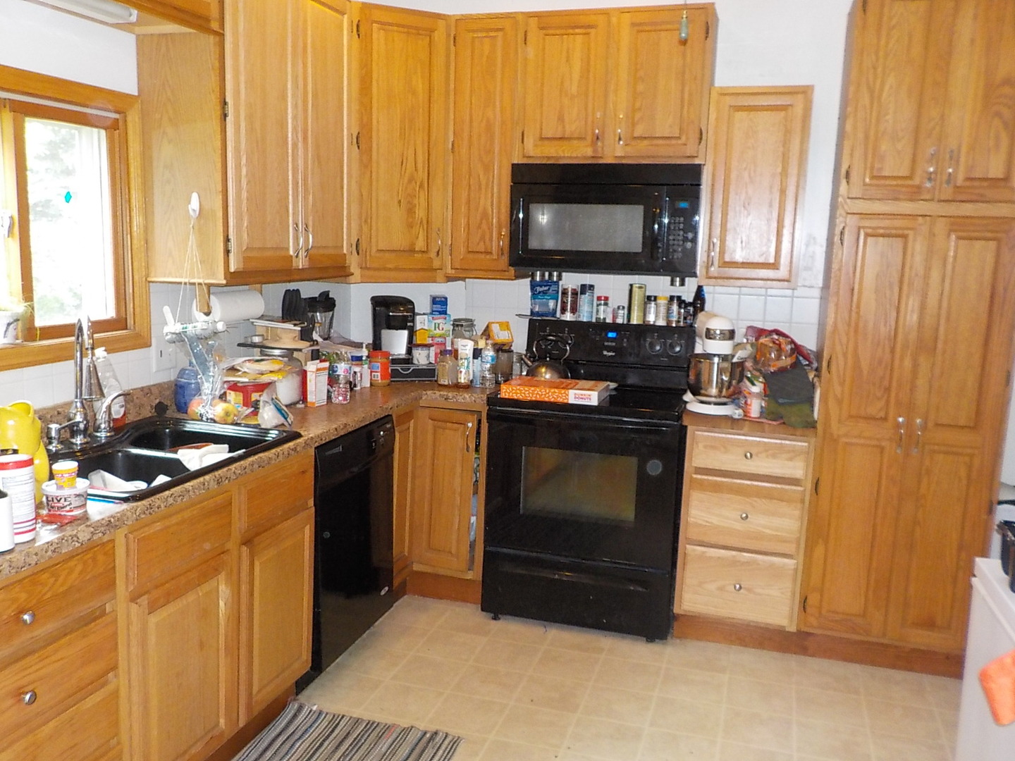 105 Main Street Kings, IL 61068 - Photo 7 of 19 a kitchen with stainless steel appliances a stove a sink and a microwave
