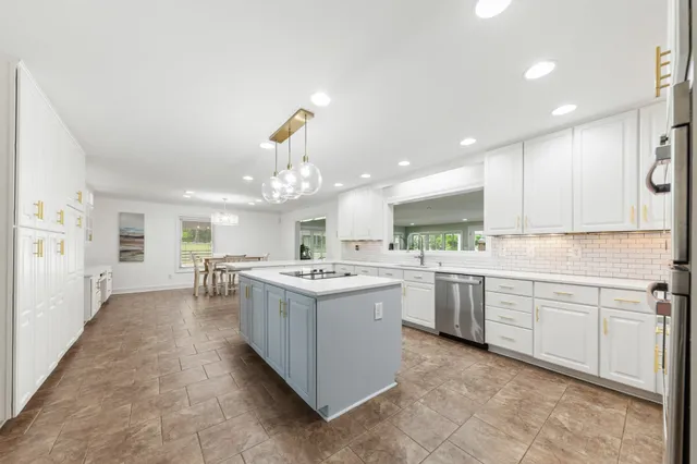 a spacious bedroom with a bed and a chandelier
