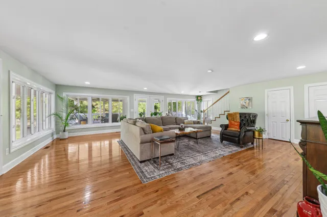a bathroom with a granite countertop toilet a sink and a mirror