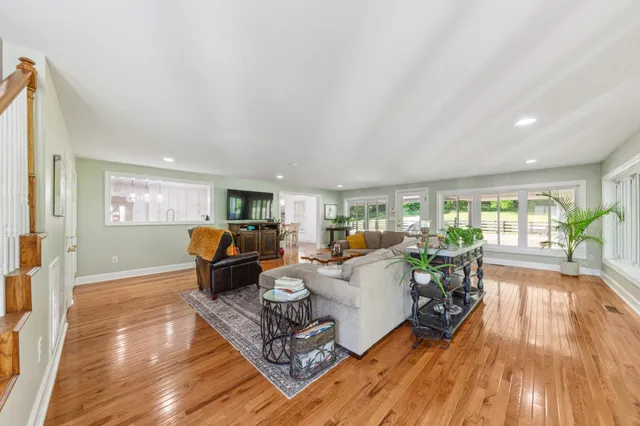a living room with furniture and a dining table