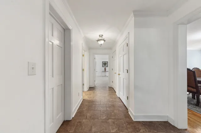 a living room with furniture and a pool table