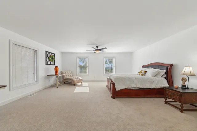 a view of a house with swimming pool and sitting area