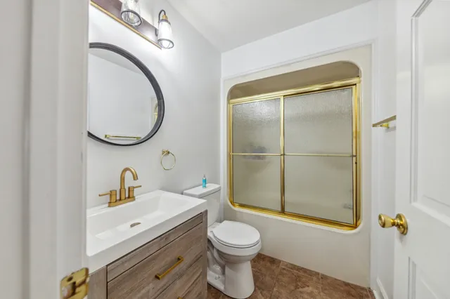 an aerial view of a house with garden space and a lake view