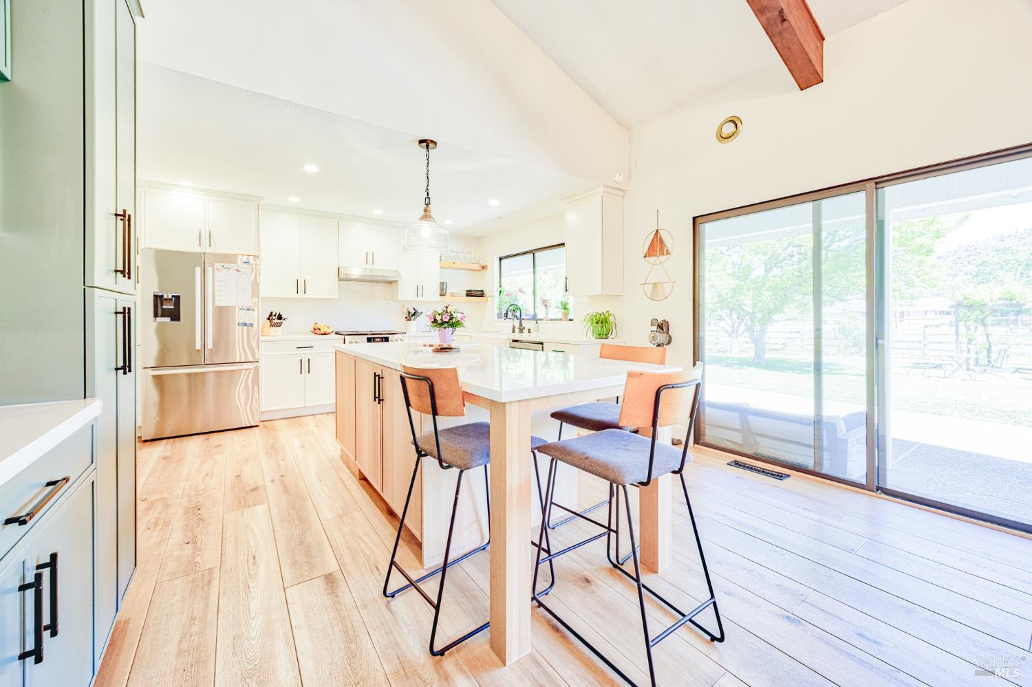 6282 Melita Road Santa Rosa, CA 95409 - Photo 17 of 55 a dining room with stainless steel appliances a dining table chairs and wooden floor
