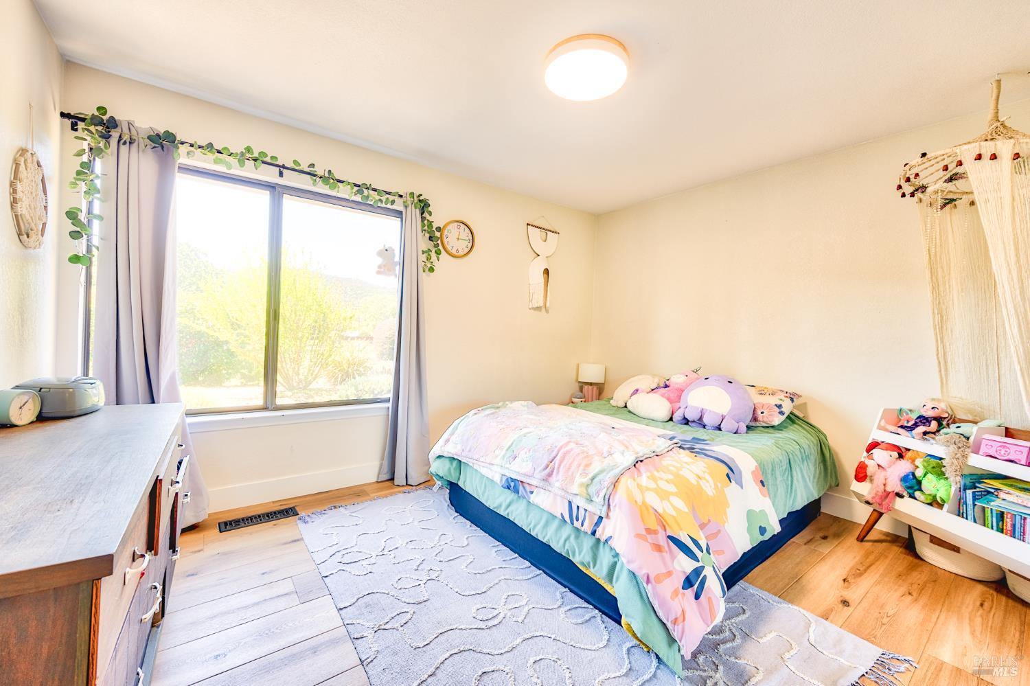 6282 Melita Road Santa Rosa, CA 95409 - Photo 21 of 55 a bedroom with a bed and a window