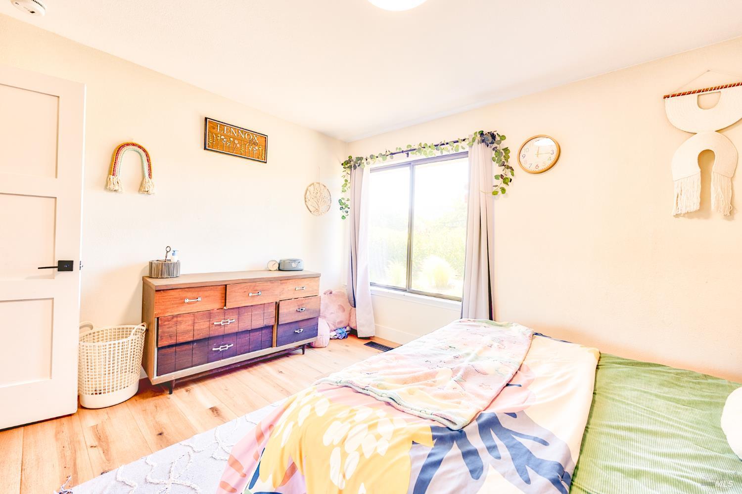 6282 Melita Road Santa Rosa, CA 95409 - Photo 23 of 55 a bedroom with a bed and a dresser