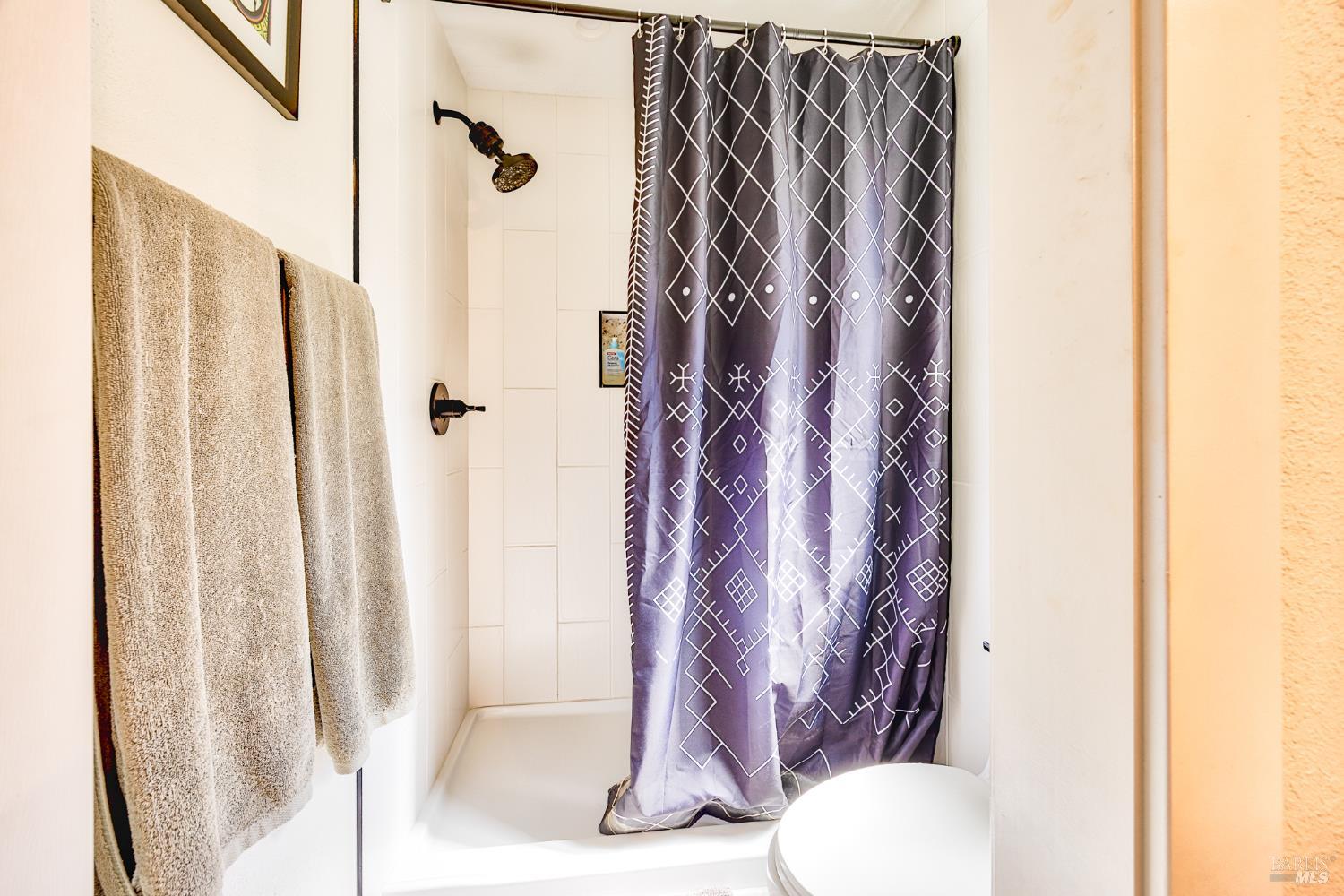 6282 Melita Road Santa Rosa, CA 95409 - Photo 34 of 55 a bathroom with a shower curtain and sink