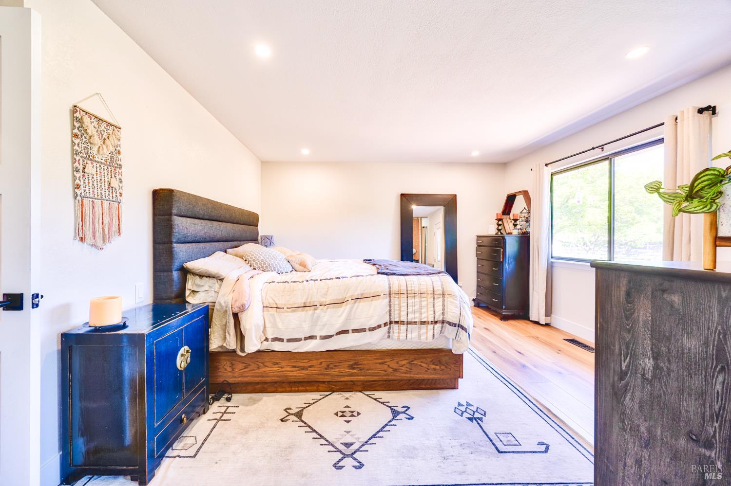 6282 Melita Road Santa Rosa, CA 95409 - Photo 35 of 55 a spacious bedroom with a bed and wooden floor