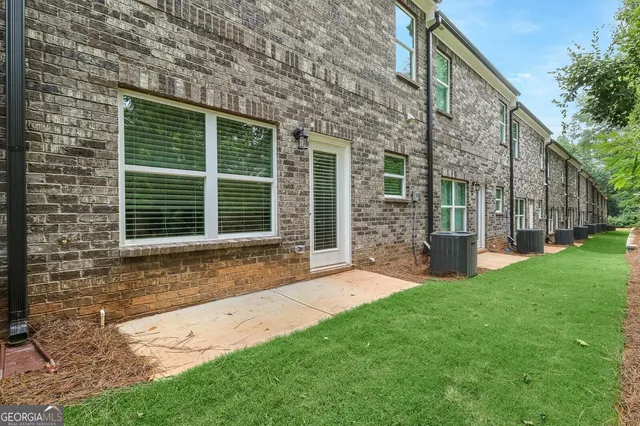 a view of a house with a yard and sitting area
