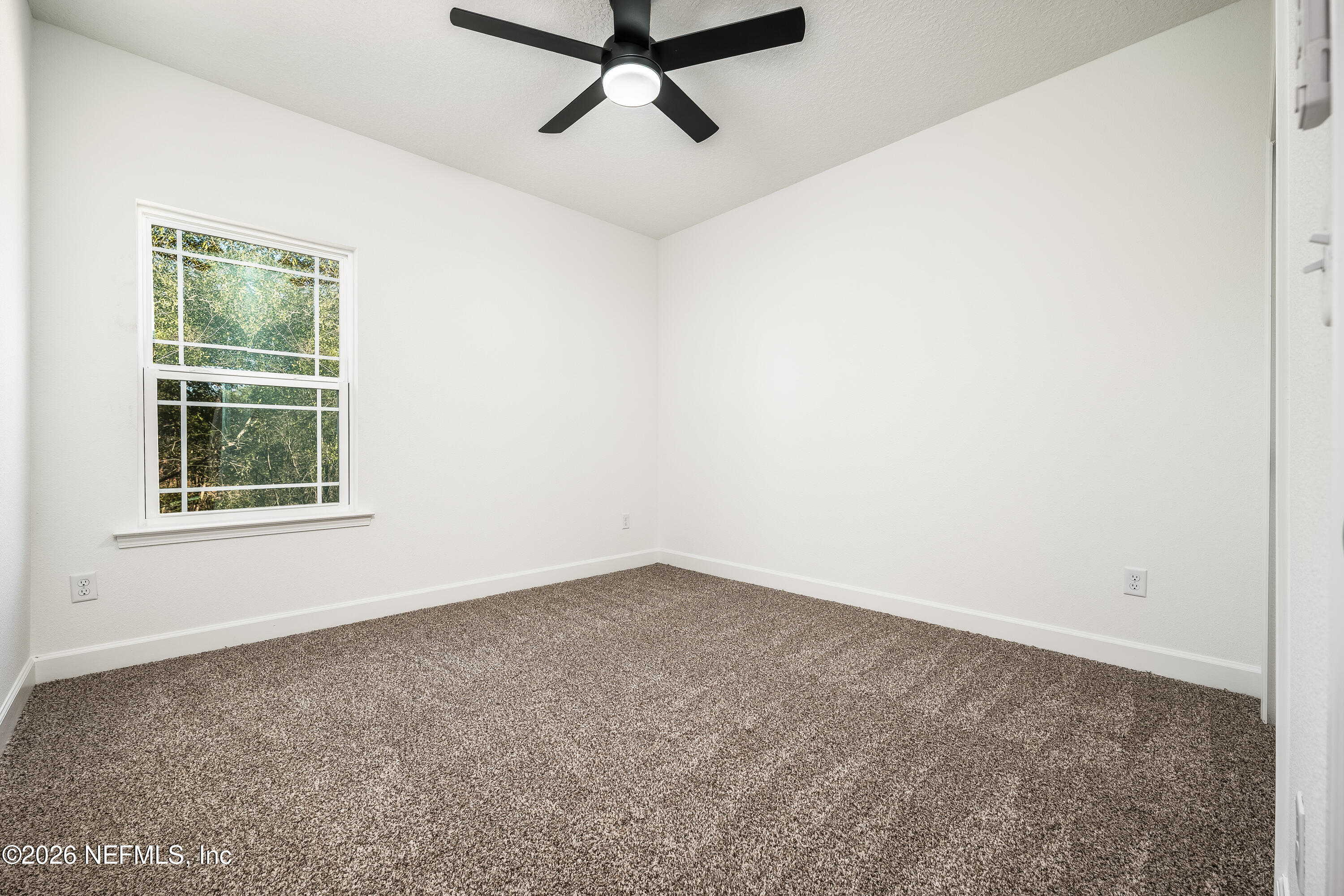 4455 Southeast 3rd Place Keystone Heights, FL 32656 - Photo 12 of 25 an empty room with windows