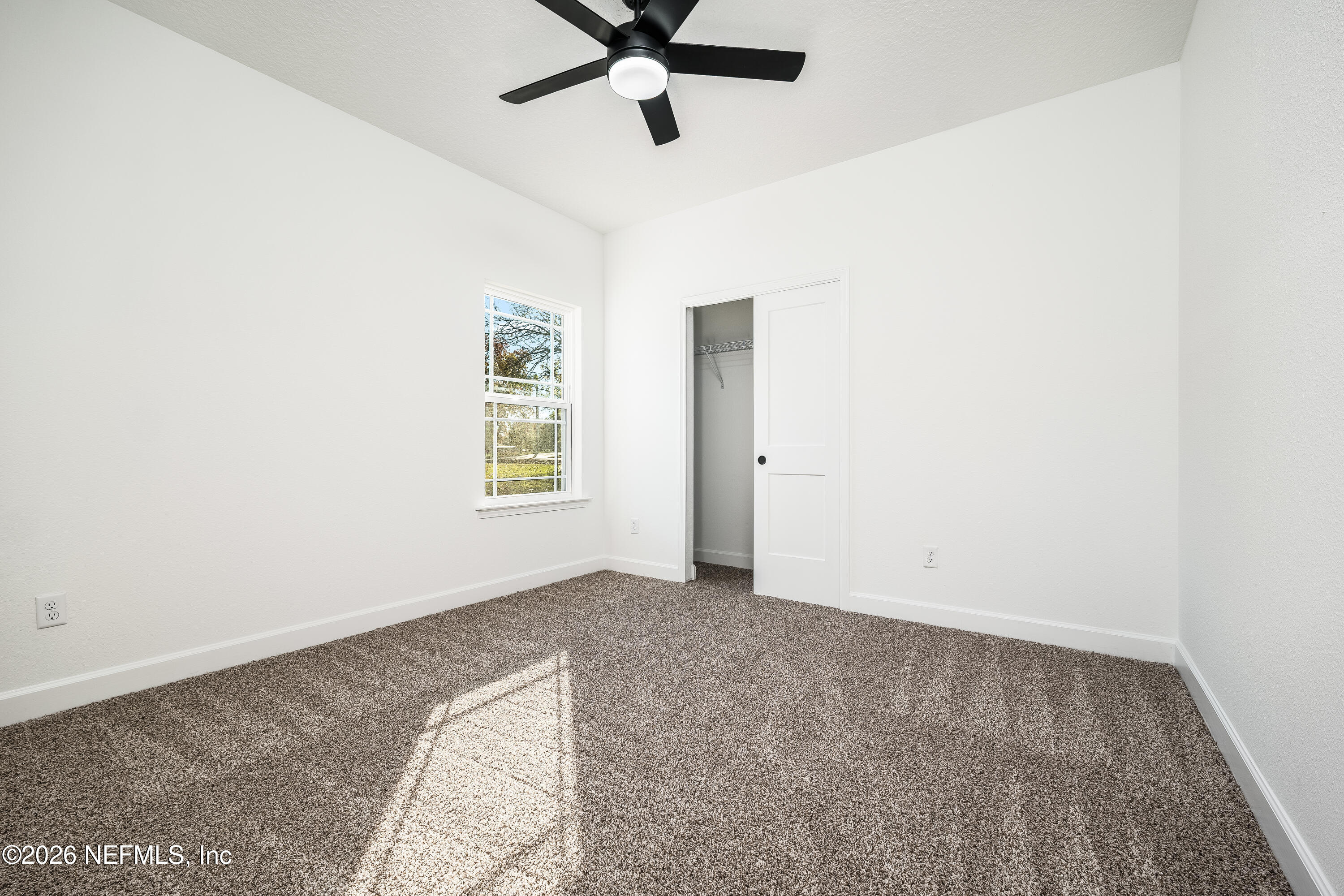 4455 Southeast 3rd Place Keystone Heights, FL 32656 - Photo 14 of 25 an empty room with windows and fan