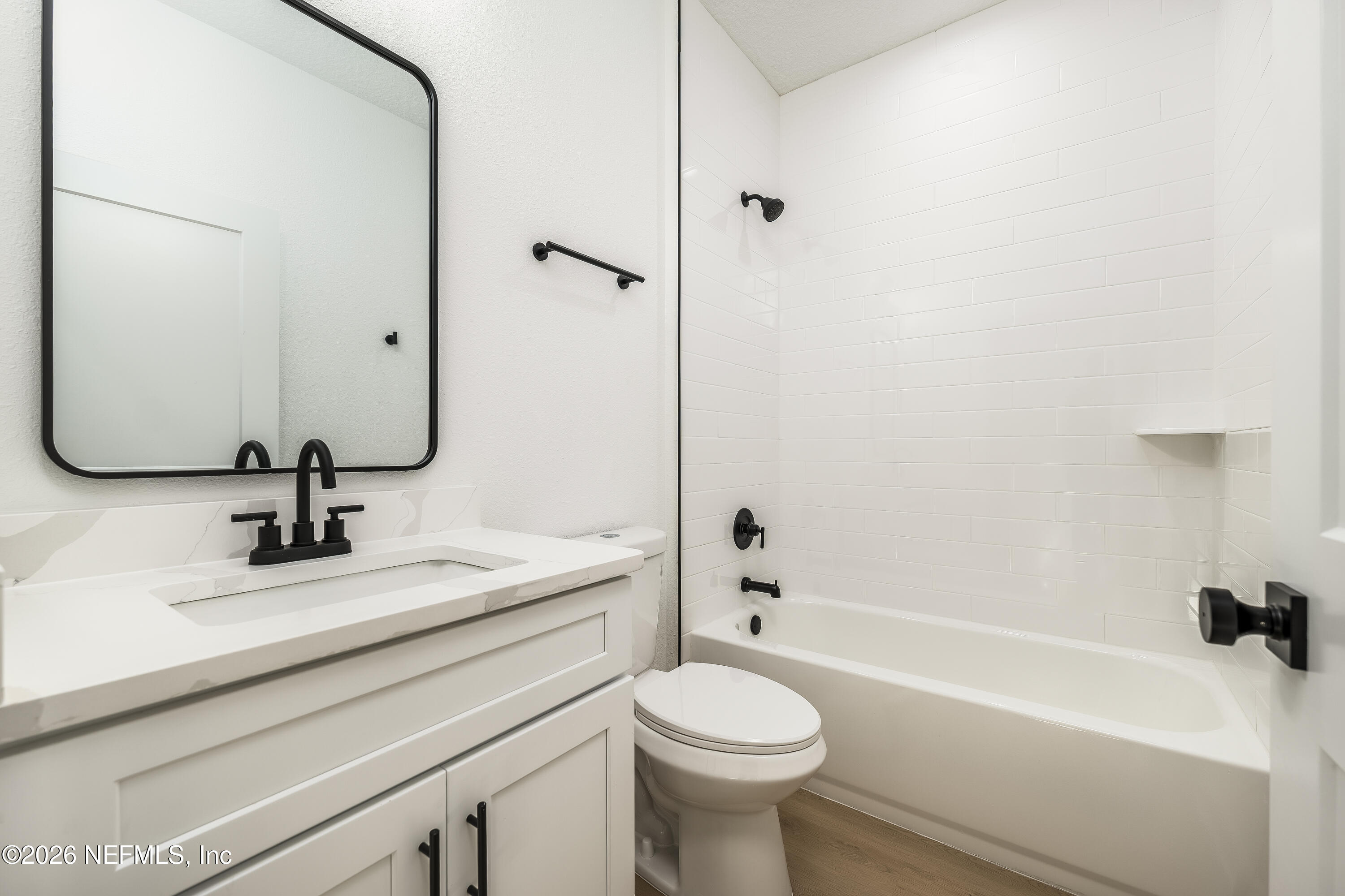 4455 Southeast 3rd Place Keystone Heights, FL 32656 - Photo 21 of 25 a bathroom with a sink a toilet and a mirror