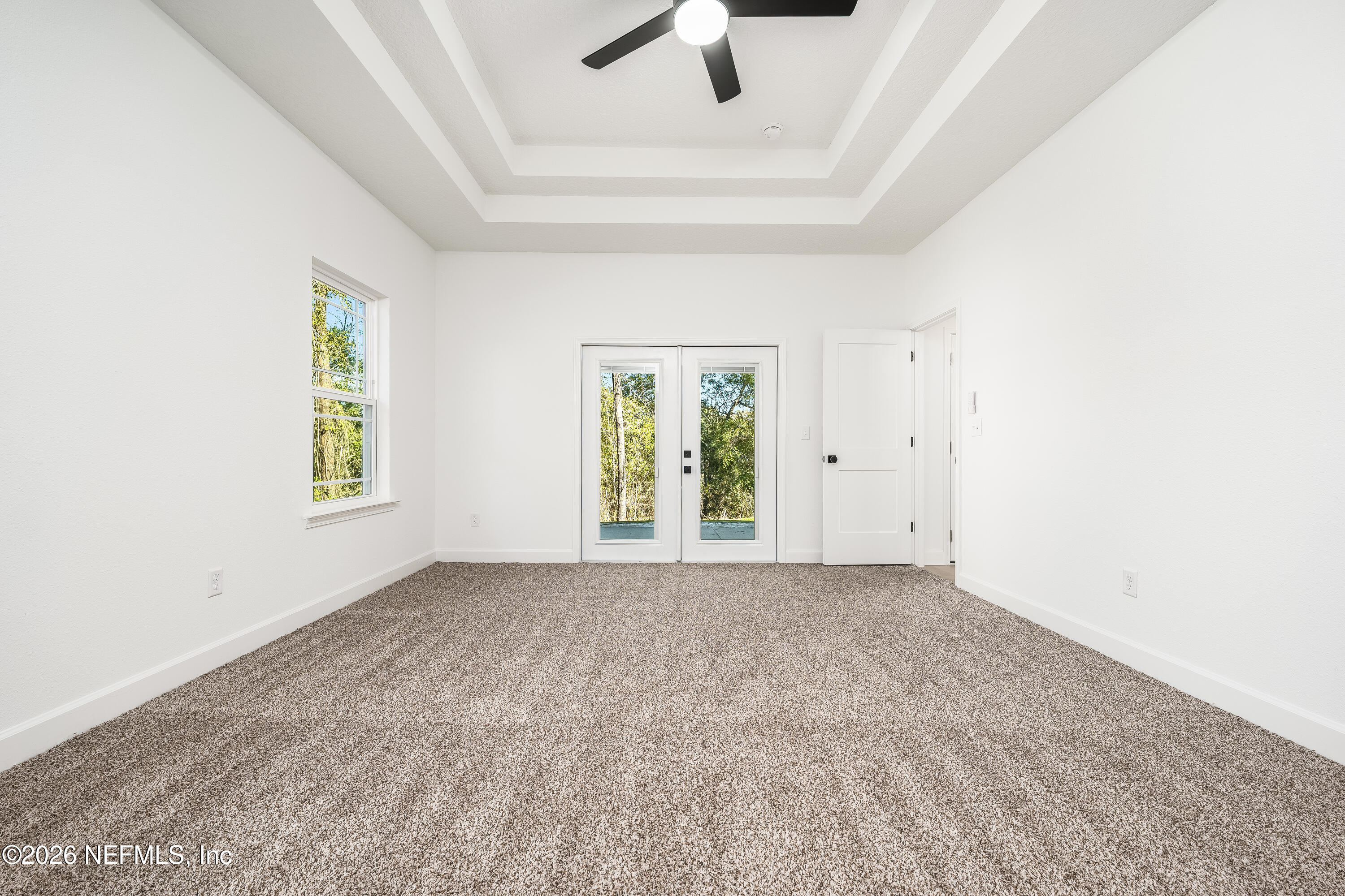 4455 Southeast 3rd Place Keystone Heights, FL 32656 - Photo 7 of 25 an empty room with windows and ceiling fan